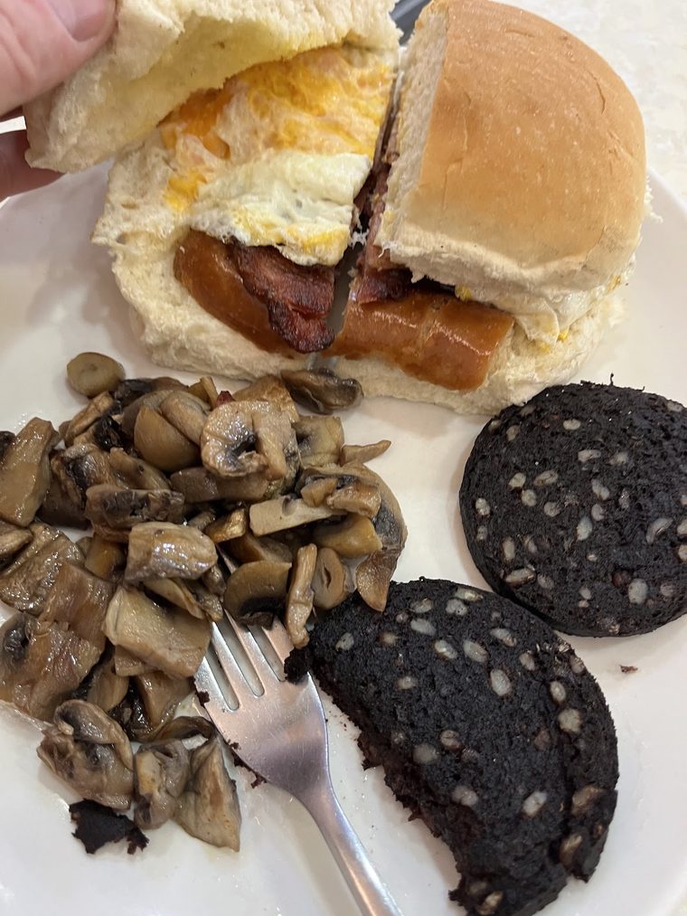 Bacon, sausage and egg roll with mushrooms and black pudding